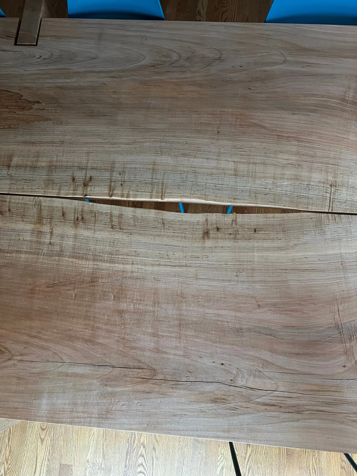 Top-down view of the two-board silver maple top, the grain running to the deliberate gap down the center.