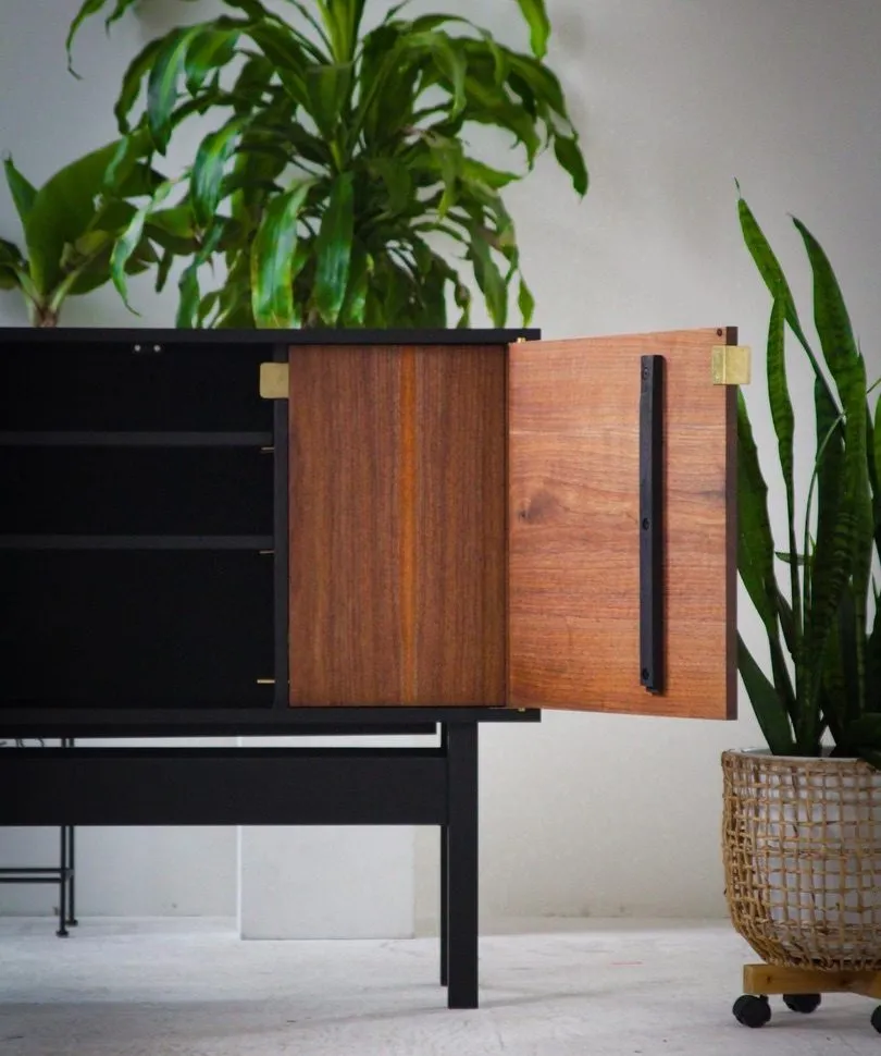 The Bradley Credenza in black stained maple and walnut with brass hardware, door open