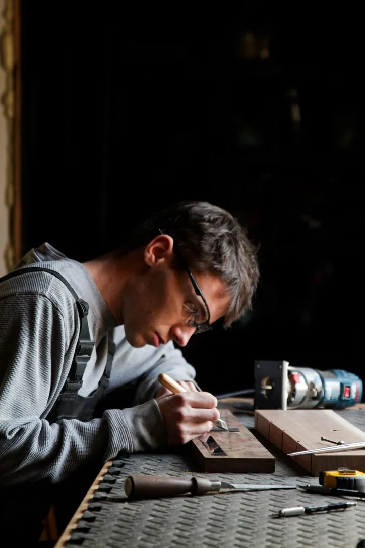 Luke Piper marking out joinery at the bench in the Pipermade shop